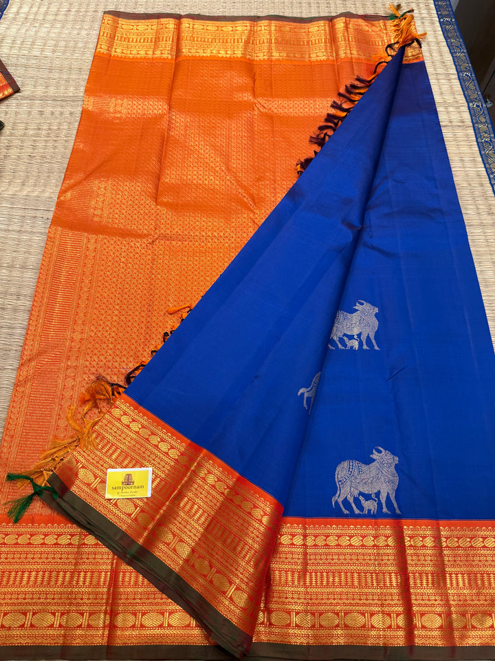 Cobalt Blue with Fanta orange, Gomatha and Kannukutty Zari Rich Butta all over the body , traditional Kanchi border and rich Pallu Korvai Pure Kanjivaram Silk saree