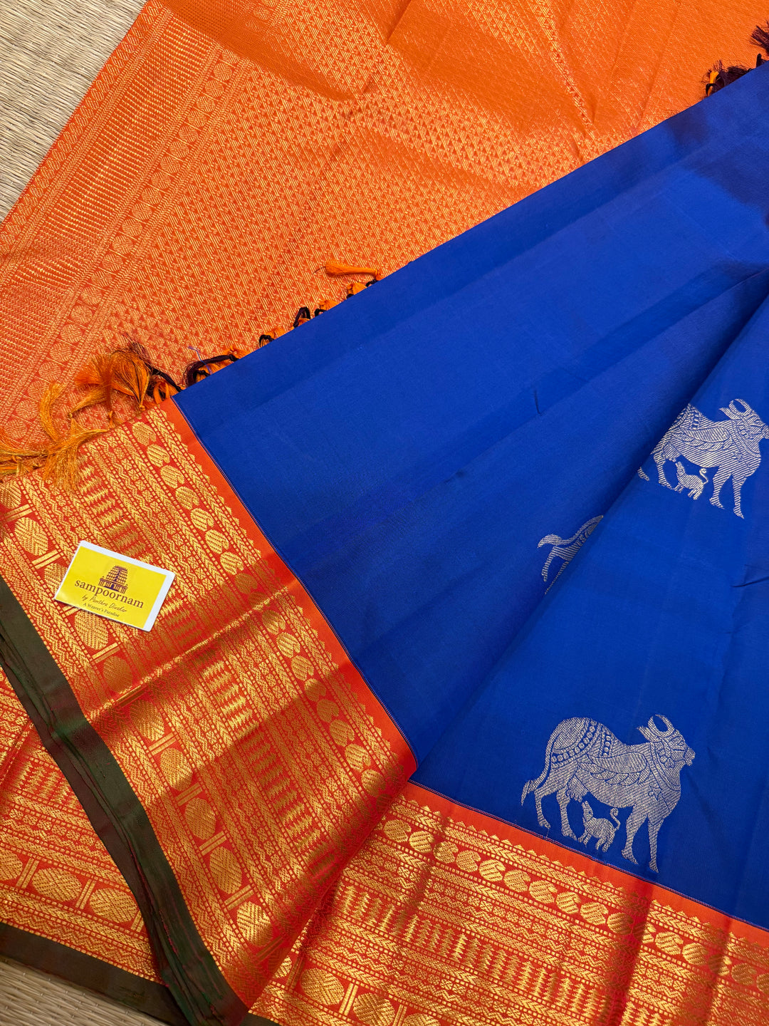 Cobalt Blue with Fanta orange, Gomatha and Kannukutty Zari Rich Butta all over the body , traditional Kanchi border and rich Pallu Korvai Pure Kanjivaram Silk saree