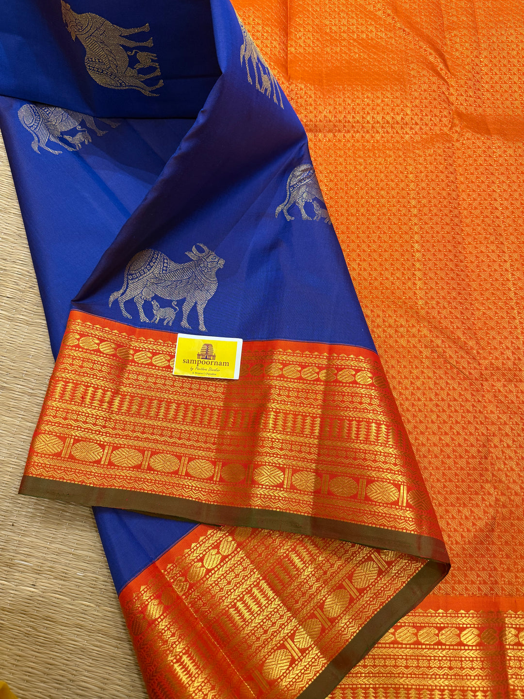 Cobalt Blue with Fanta orange, Gomatha and Kannukutty Zari Rich Butta all over the body , traditional Kanchi border and rich Pallu Korvai Pure Kanjivaram Silk saree