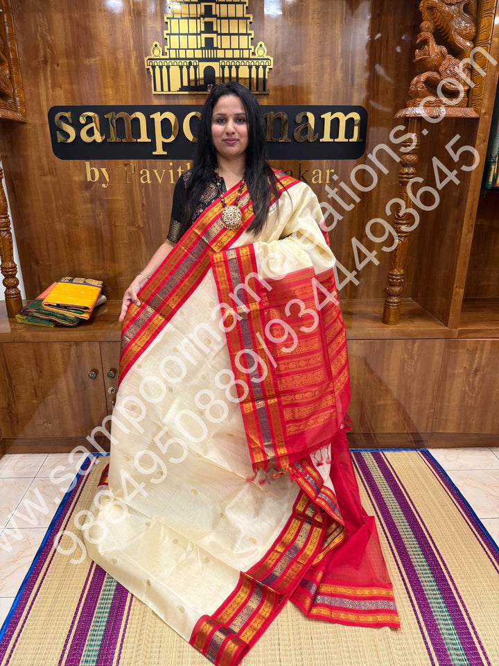 Cream with Red , rich Mango and Rudraksh Zari butta in the body , traditional Kanchi Borders , rich traditional borders and Grand Pallu Korvai Silk Cotton Saree