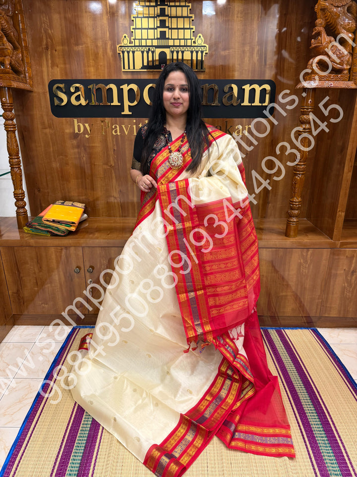 Cream with Red , rich Mango and Rudraksh Zari butta in the body , traditional Kanchi Borders , rich traditional borders and Grand Pallu Korvai Silk Cotton Saree