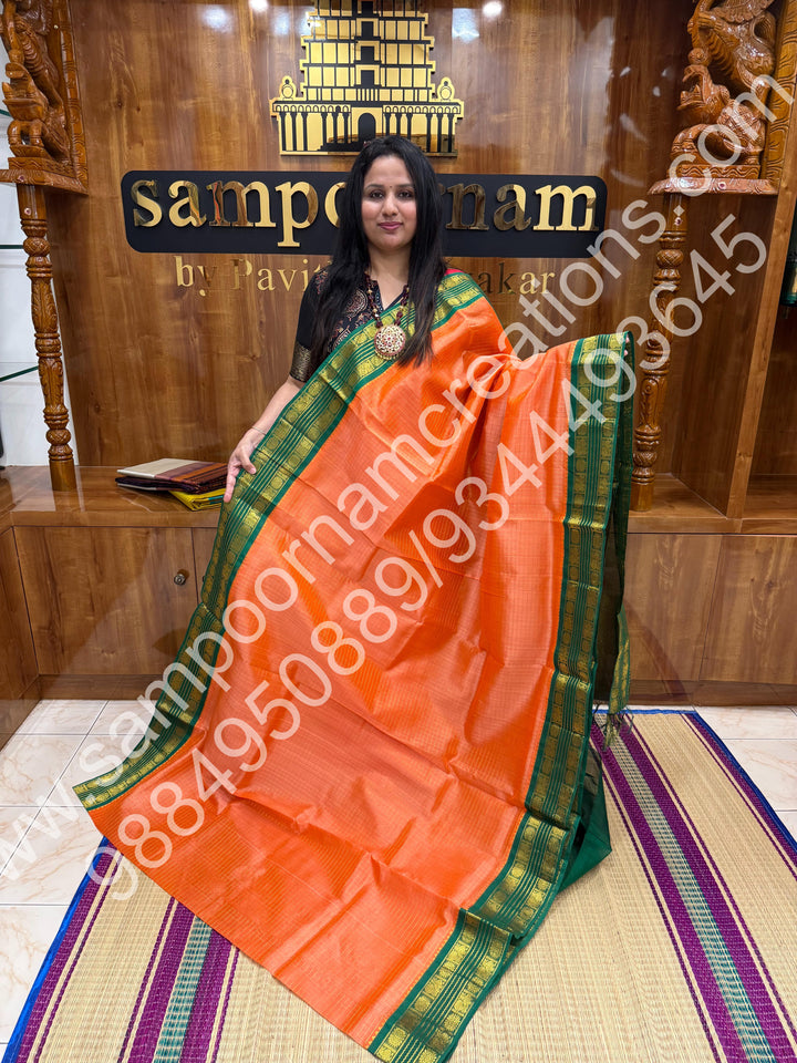 Light Kanakambaram with Green  , rich Zari Kattam in the body , rettapet border and rich Pallu Korvai Silk Cotton Saree