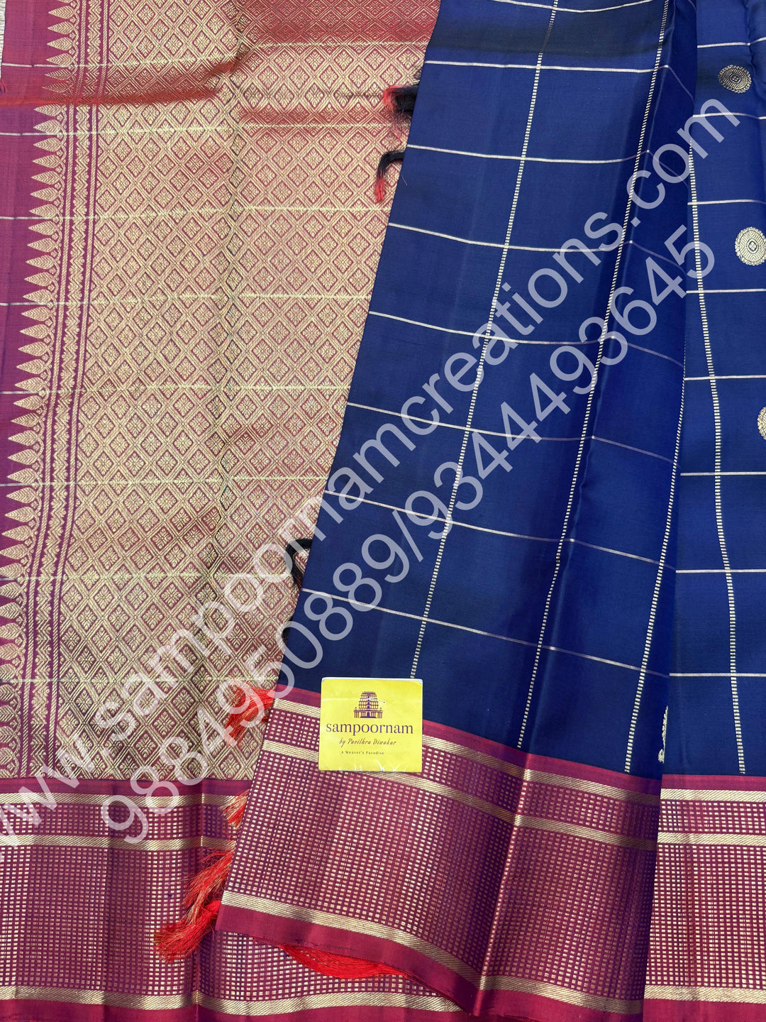 Dark Blue with Mauve , Rich Mayil and Chakram  butta in the body with Zari checks , Traditional borders and Rich Pallu , Pure Kanjivaram Silk Saree