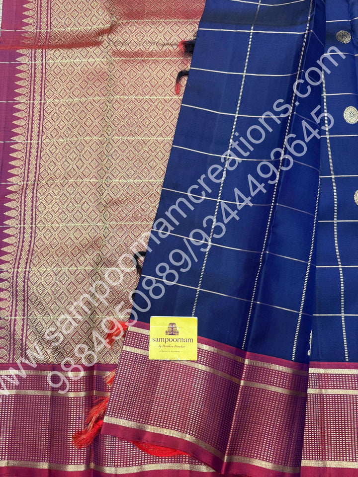 Dark Blue with Mauve , Rich Mayil and Chakram  butta in the body with Zari checks , Traditional borders and Rich Pallu , Pure Kanjivaram Silk Saree