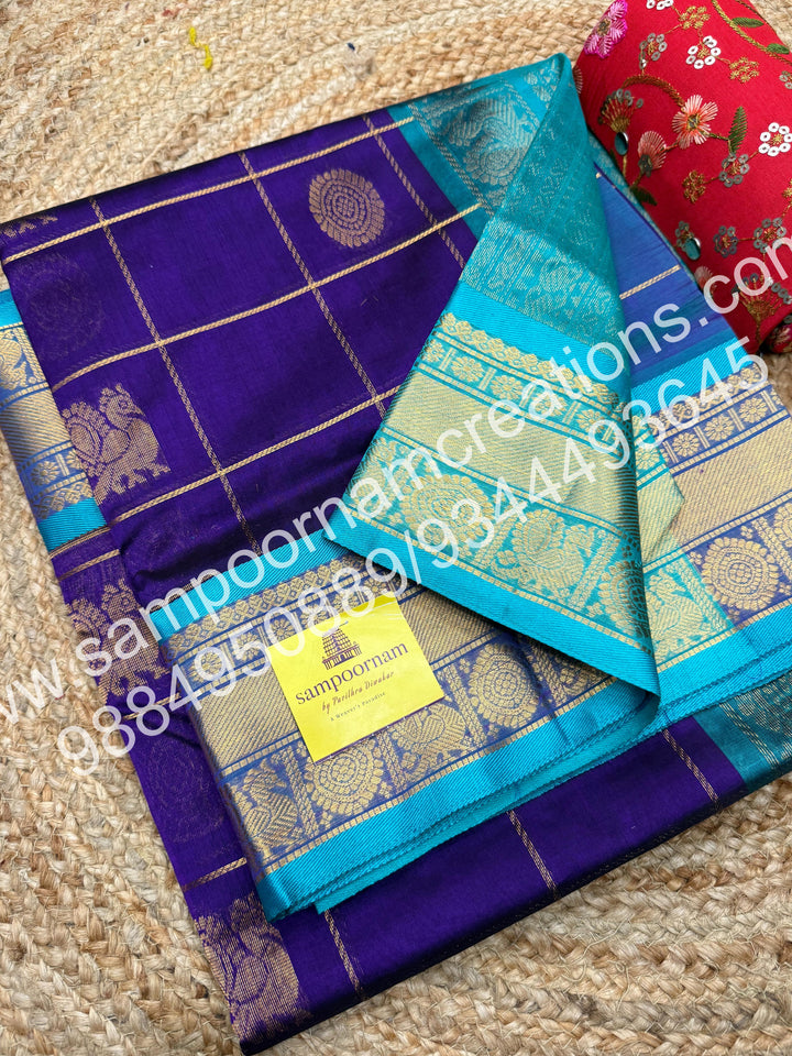 Violet with Turquoise Blue , Rich Mayil and Chakram butta in the body with Zari Checks, traditional borders and Rich Pallu , Pure Silk Cotton Saree