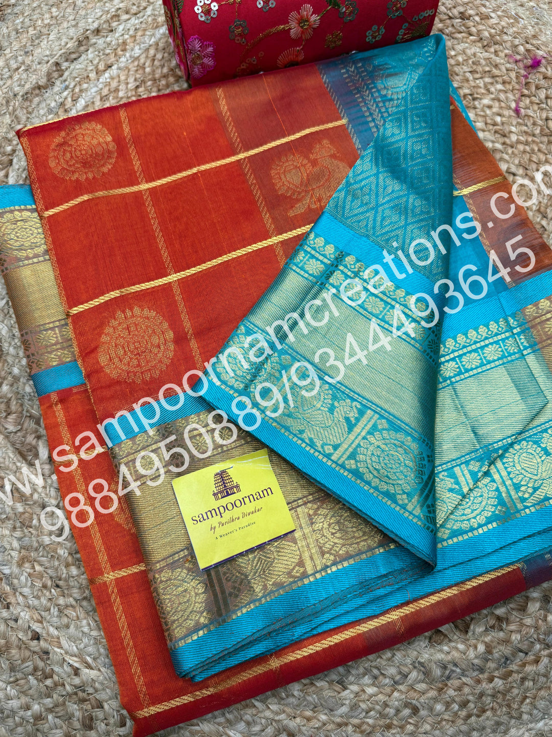 Rust Orange wuth Turquoise Blue , Rich Mayil and Chakram butta in the body with Zari Checks, traditional borders and Rich Pallu , Pure Silk Cotton Saree