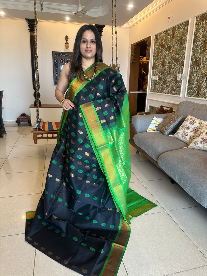 Black with green ,mango and annam rich butta in the body,traditional borders and rich pallu semi silk cotton saree