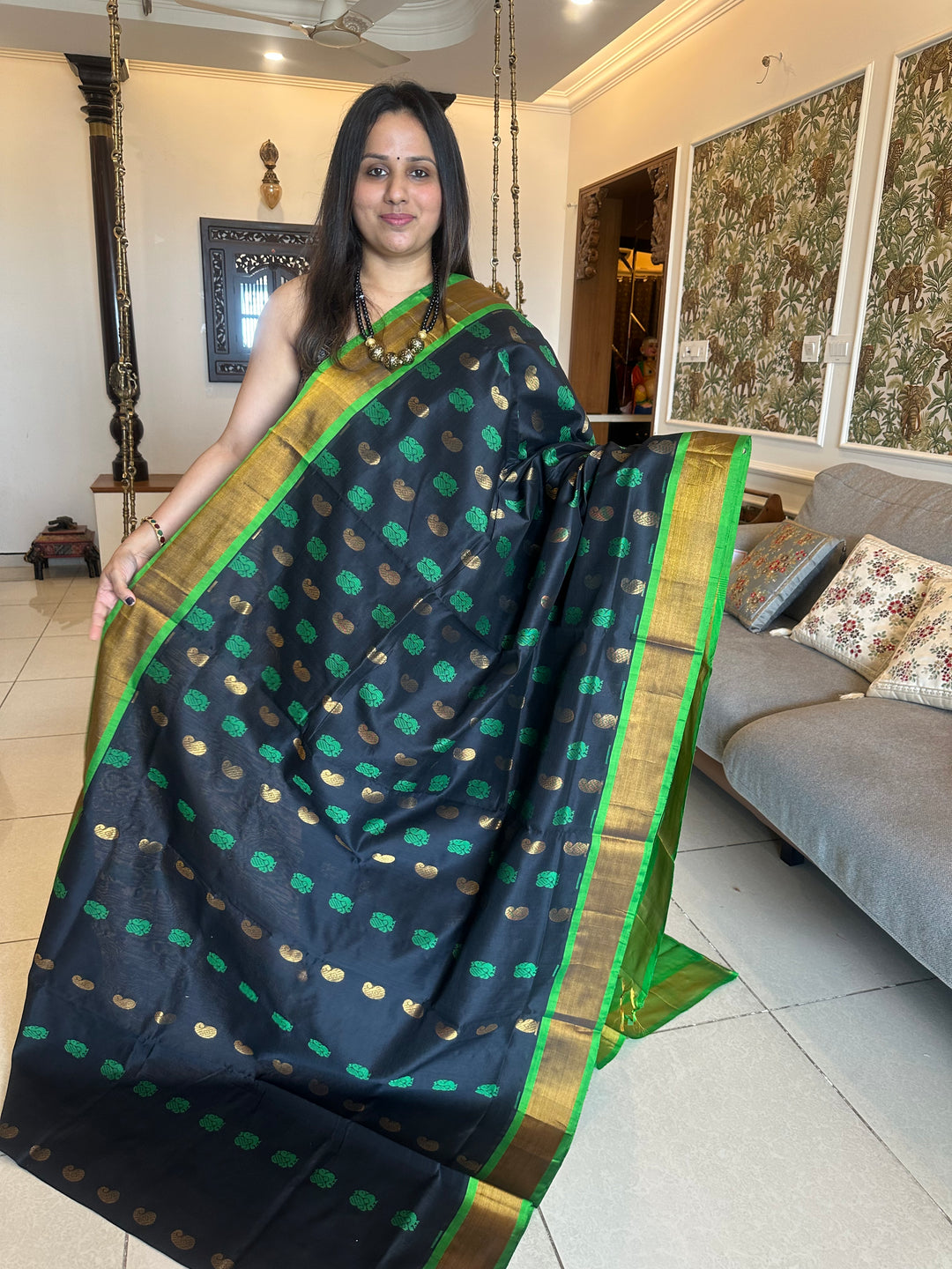 Black with green ,mango and annam rich butta in the body,traditional borders and rich pallu semi silk cotton saree