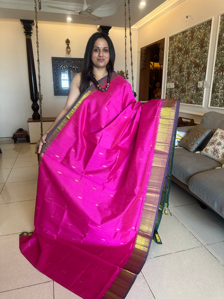 Green with pink rich butta in the body,traditional borders and rich pallu semi silk cotton saree