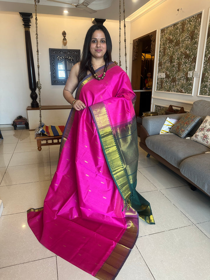 Green with pink rich butta in the body,traditional borders and rich pallu semi silk cotton saree