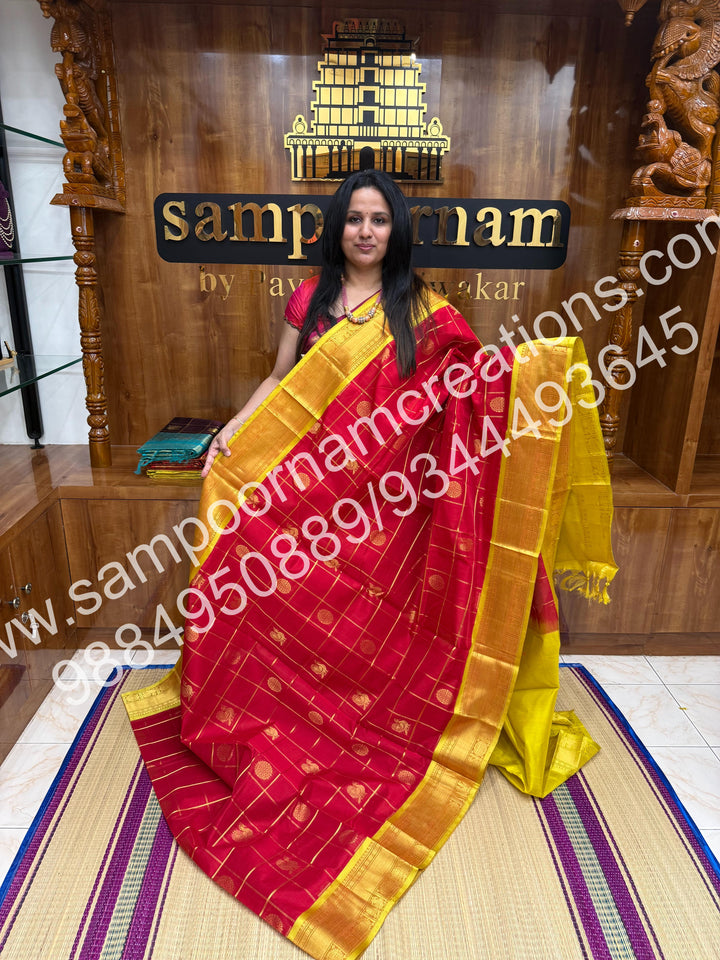 Red with Lemon Yellow , Rich Mayil and Chakram butta in the body with Zari Checks, traditional borders and Rich Pallu , Pure Silk Cotton Saree