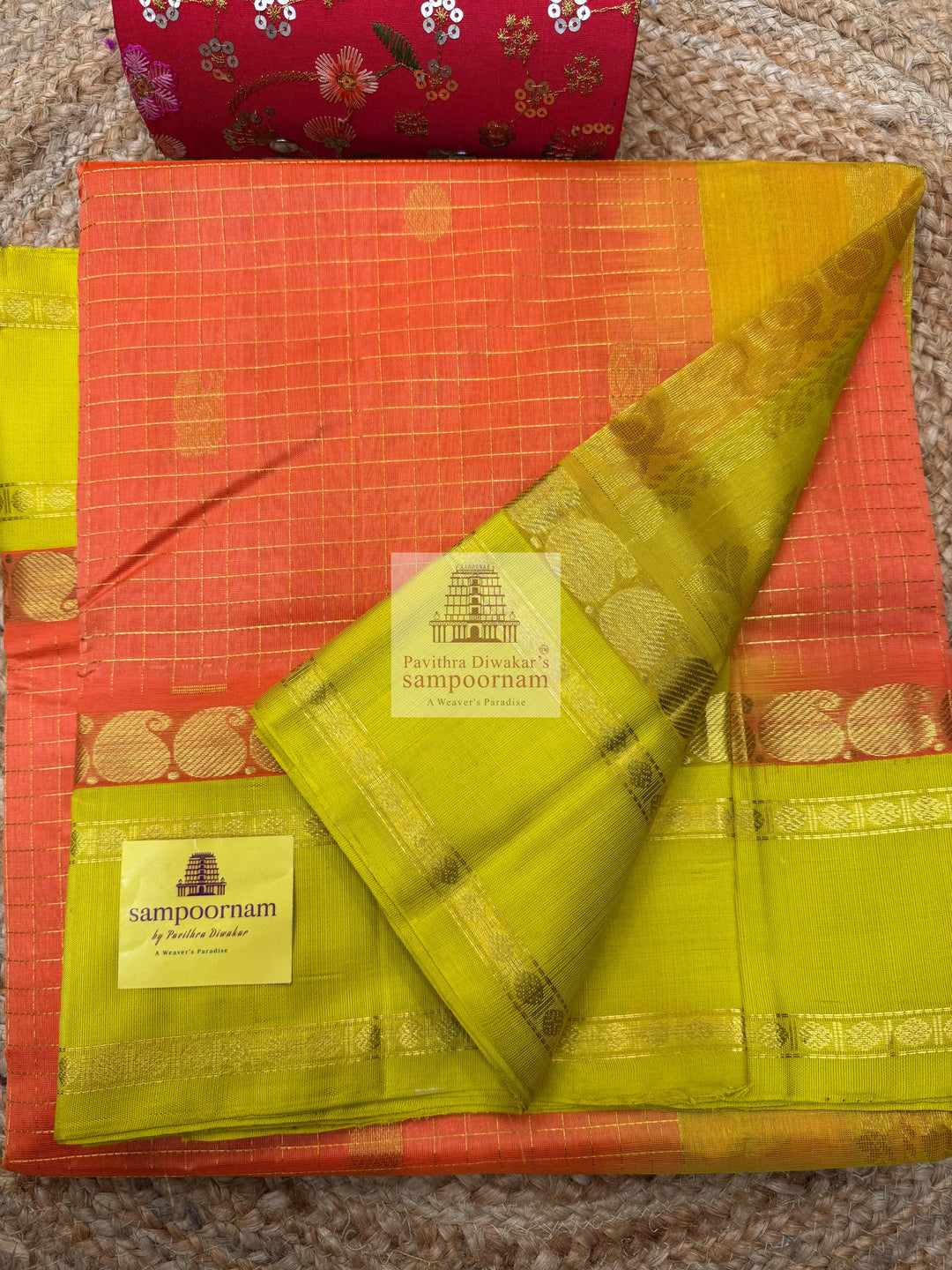 Orange with Lemon Yellow , rich Zari checks in the body , Mayil and Chakram rich butta in the body , traditional borders and Rich Pallu Korvai Silk Cotton Saree