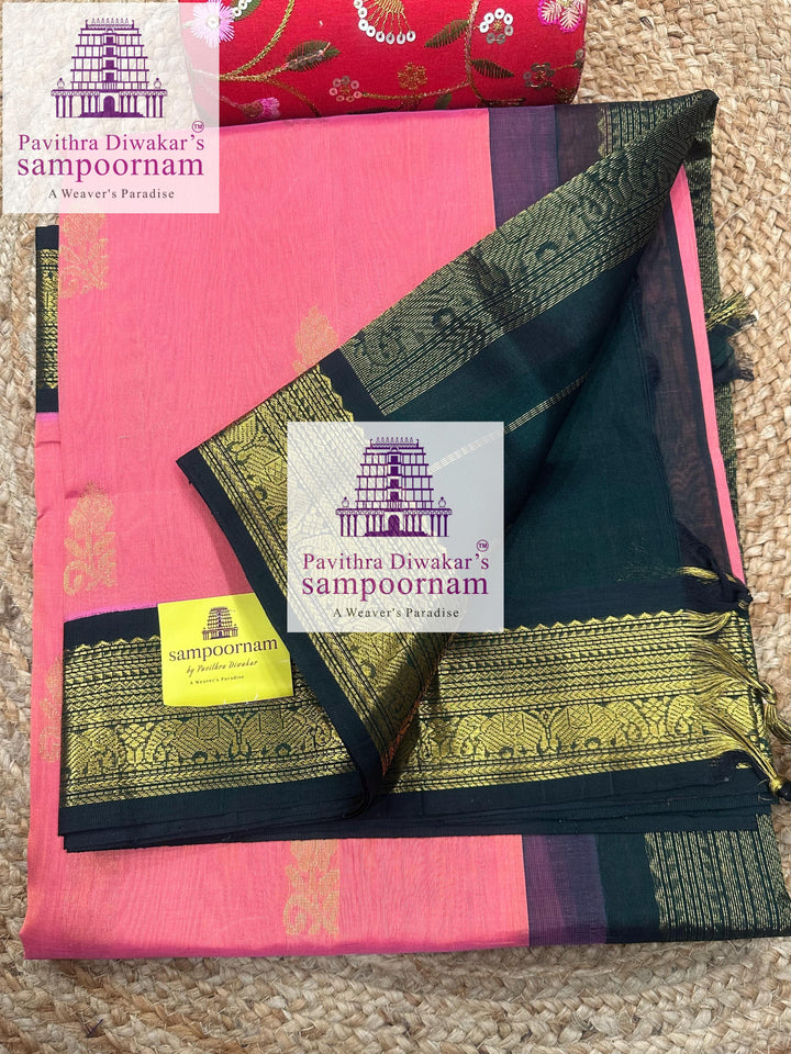 Peachish Pink with Dark Green , rich Zari butta in the body ,traditional boders and rich Pallu Korvai Silk Cotton Saree