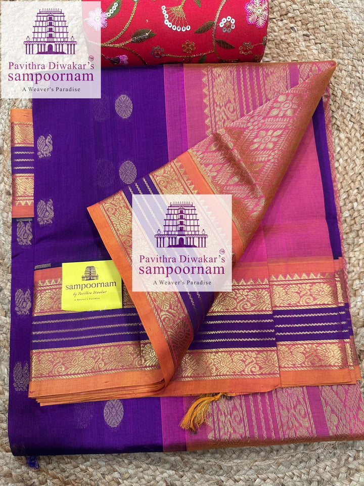 Purple with Peachish Pink , rich Zari butta in the body and Kanchi traditional borders and rich Pallu Korvai Silk Cotton Saree