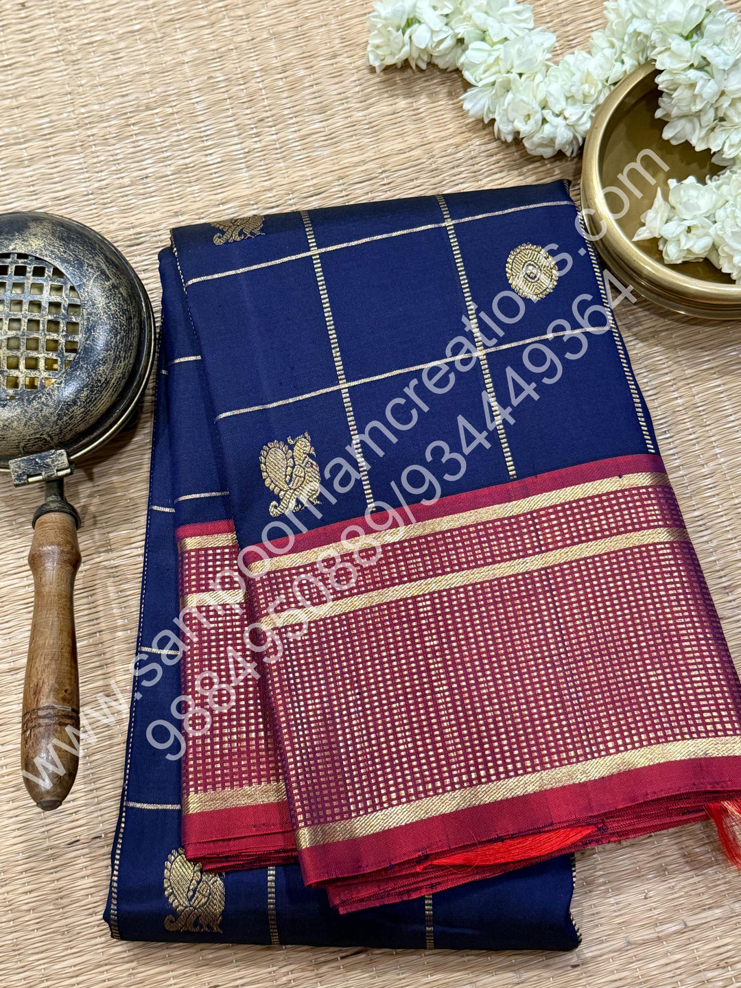 Dark Blue with Mauve , Rich Mayil and Chakram  butta in the body with Zari checks , Traditional borders and Rich Pallu , Pure Kanjivaram Silk Saree