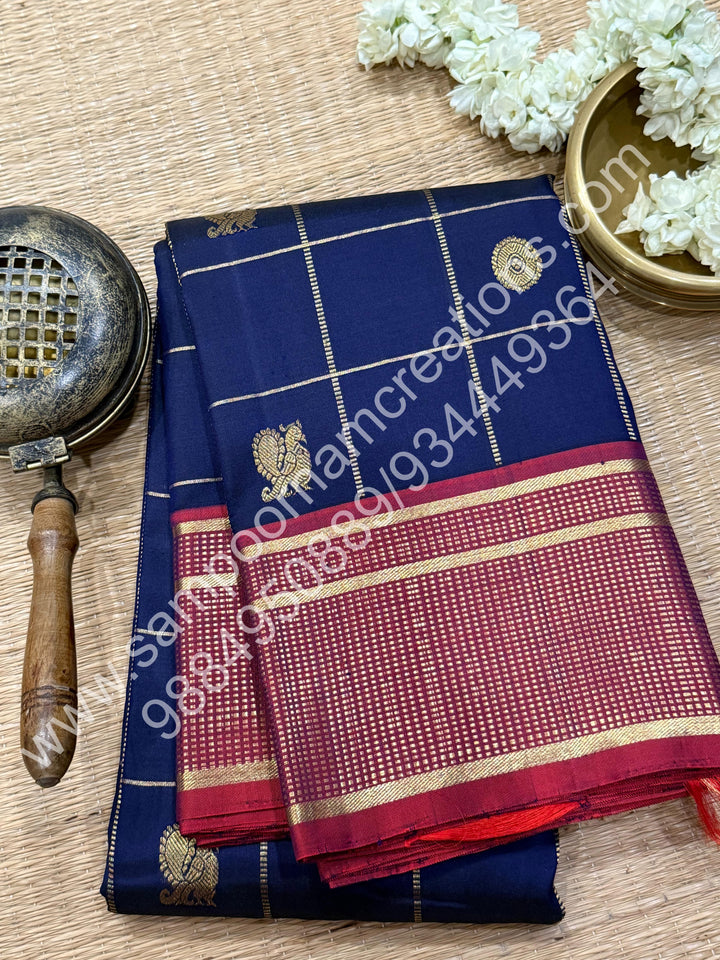 Dark Blue with Mauve , Rich Mayil and Chakram  butta in the body with Zari checks , Traditional borders and Rich Pallu , Pure Kanjivaram Silk Saree
