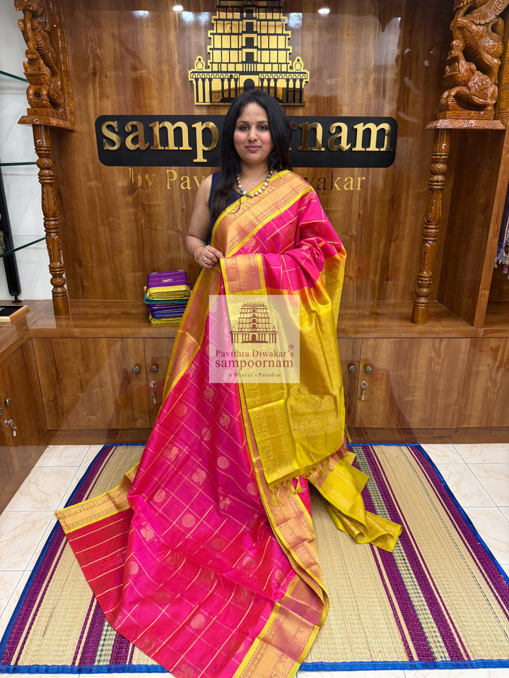 Rani pink with Lemon Yellow, , rich Zari checks in the body , Mayil and Chakram rich Zari butta in the body , traditional borders and rich Pallu Silk Cotton Saree