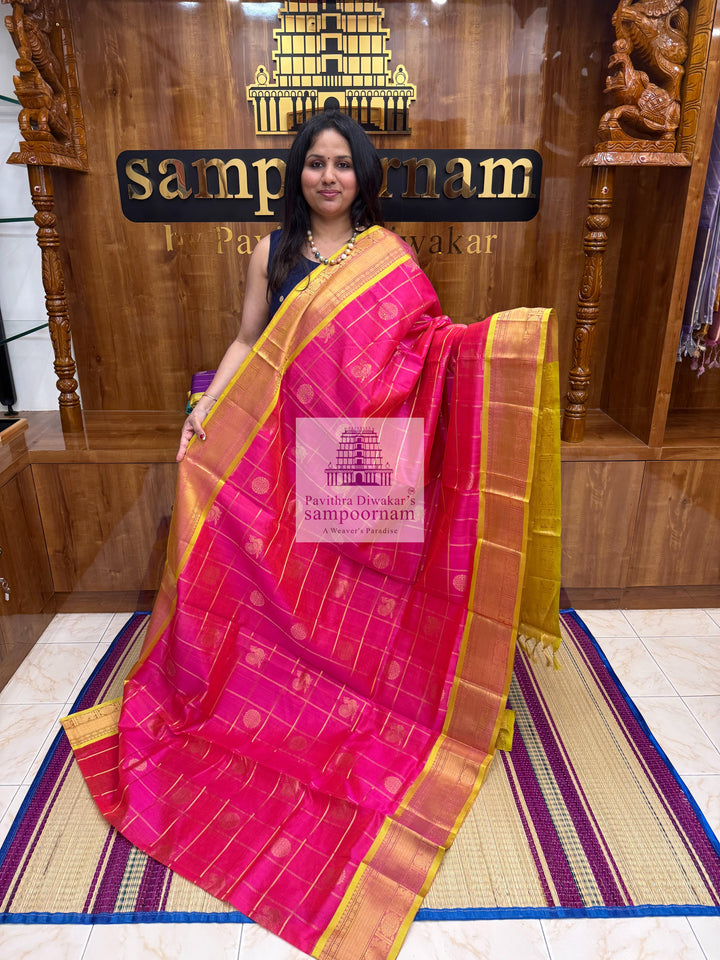 Rani pink with Lemon Yellow, , rich Zari checks in the body , Mayil and Chakram rich Zari butta in the body , traditional borders and rich Pallu Silk Cotton Saree