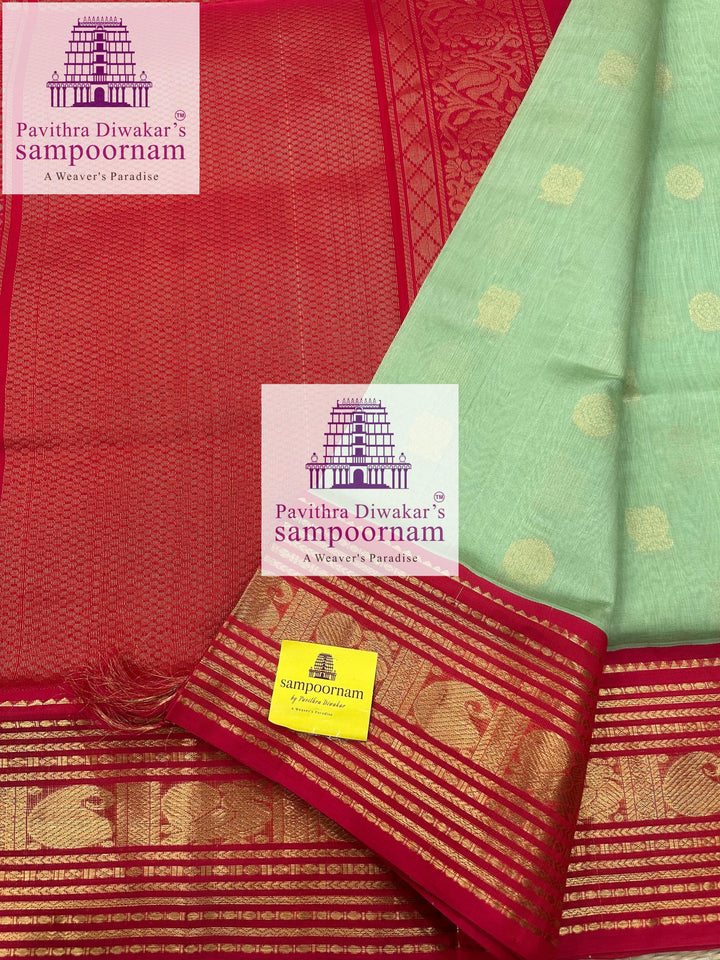 Pastel Green with Red , rich Zari butta in the body , traditional Kanchi borders and grand ,rich Zari butta in the body, traditional borders and rich Pallu Korvai Silk Cotton Sare