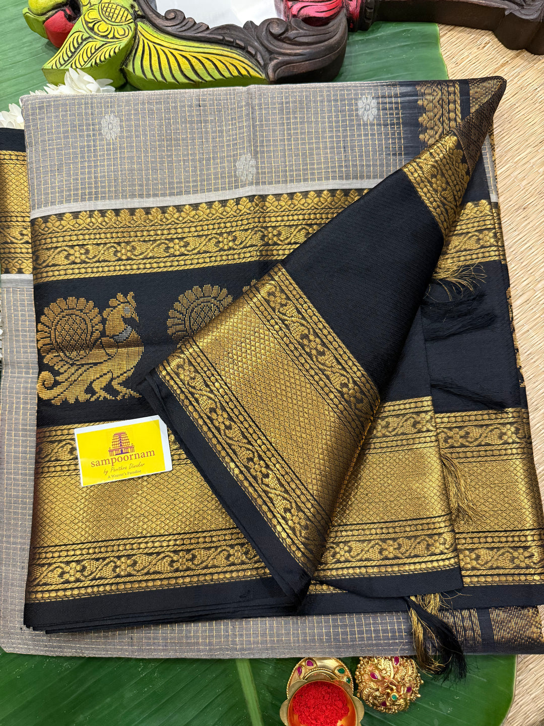 Grey with Black zari podi kattam in the body,satin border with annam motif, rich border and pallu korvai silk  cotton saree