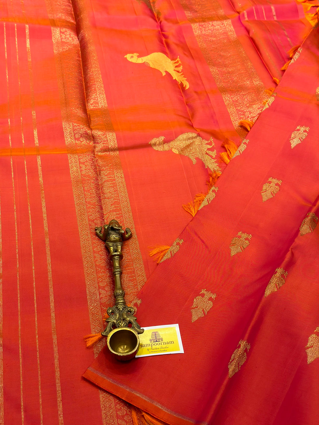 A very Elite Orangish Pink Borderless Silk Saree with Gandaberunda Zari motif, with Kalakshetra Kili Rich Pallu Kanjivaram Silk Saree. Pure Silk & Pure Zari