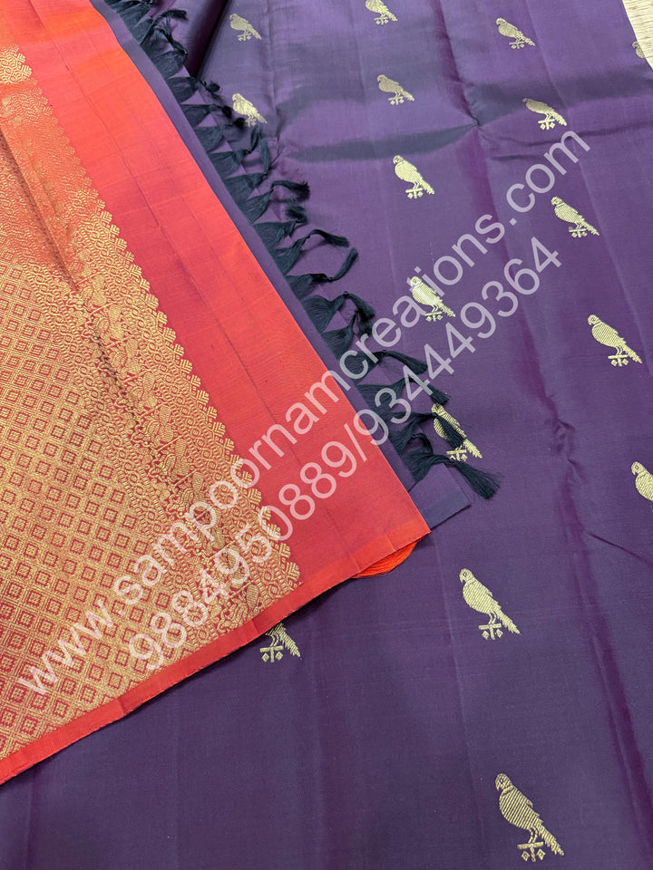 Dark Jamun with Rust Orange , Rich Parrot Zari  butta in the body  and  a Rich Pallu , Pure Kanjivaram Silk Saree