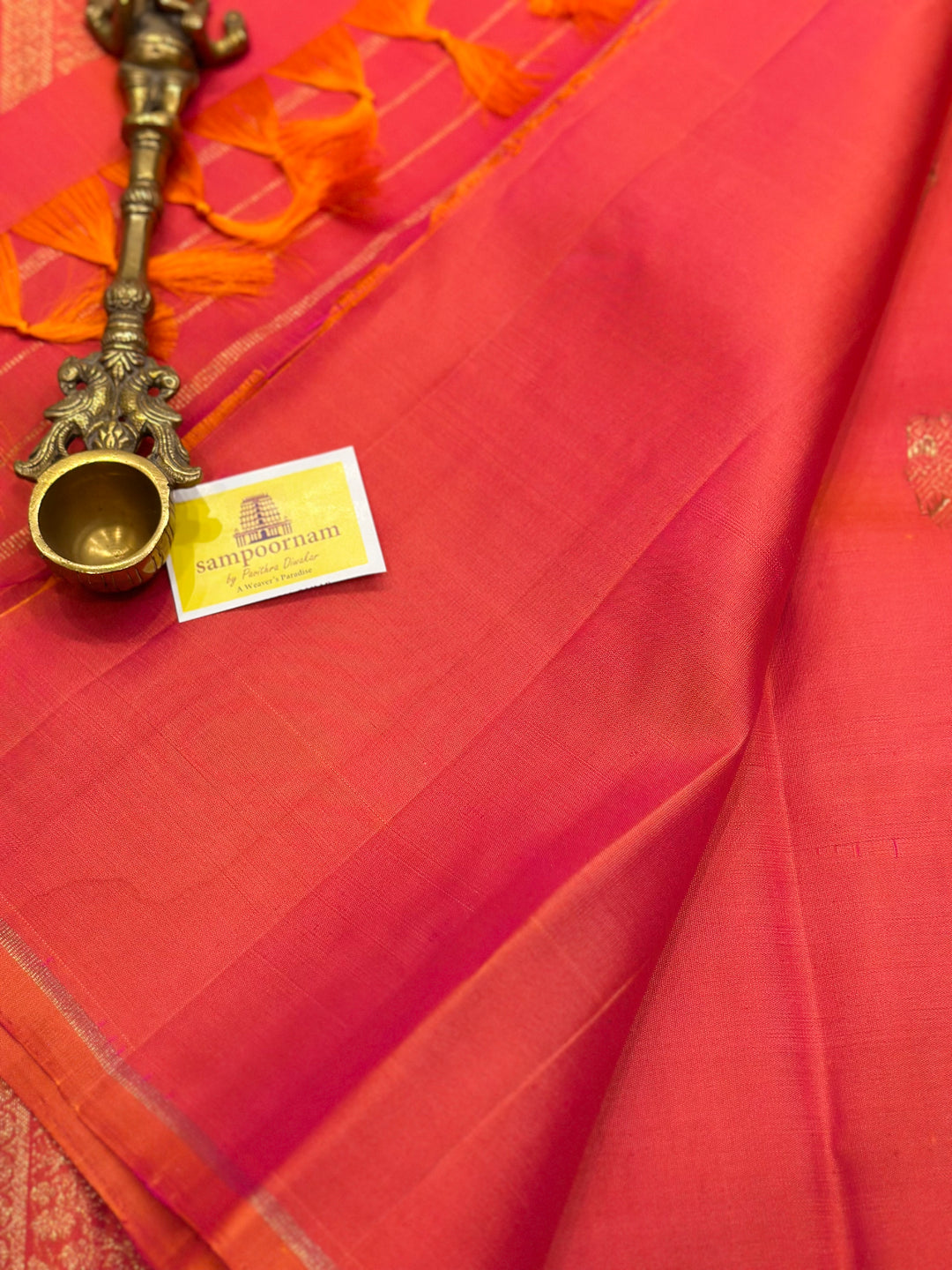 A very Elite Orangish Pink Borderless Silk Saree with Gandaberunda Zari motif, with Kalakshetra Kili Rich Pallu Kanjivaram Silk Saree. Pure Silk & Pure Zari