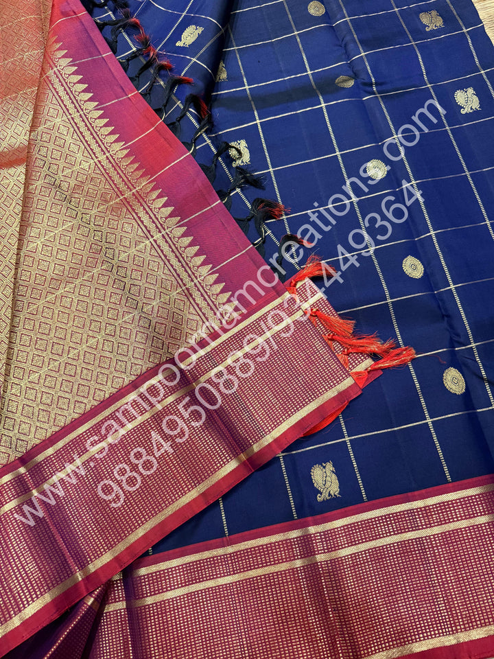 Dark Blue with Mauve , Rich Mayil and Chakram  butta in the body with Zari checks , Traditional borders and Rich Pallu , Pure Kanjivaram Silk Saree