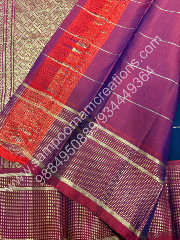 Dark Blue with Mauve , Rich Mayil and Chakram  butta in the body with Zari checks , Traditional borders and Rich Pallu , Pure Kanjivaram Silk Saree