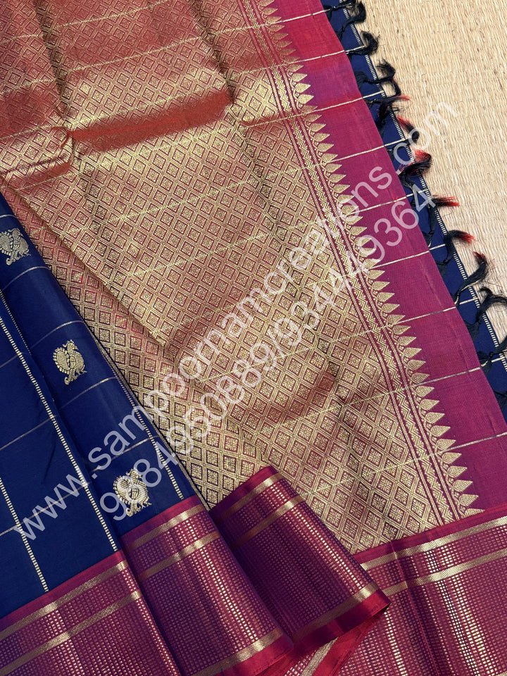 Dark Blue with Mauve , Rich Mayil and Chakram  butta in the body with Zari checks , Traditional borders and Rich Pallu , Pure Kanjivaram Silk Saree