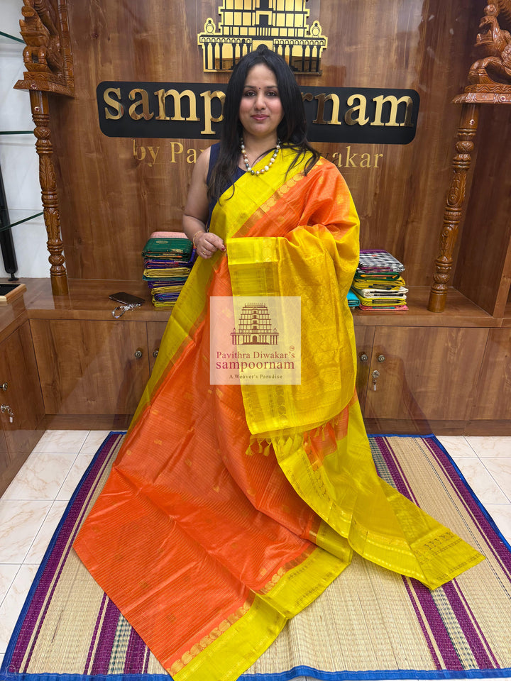 Orange with Lemon Yellow , rich Zari checks in the body , Mayil and Chakram rich butta in the body , traditional borders and Rich Pallu Korvai Silk Cotton Saree