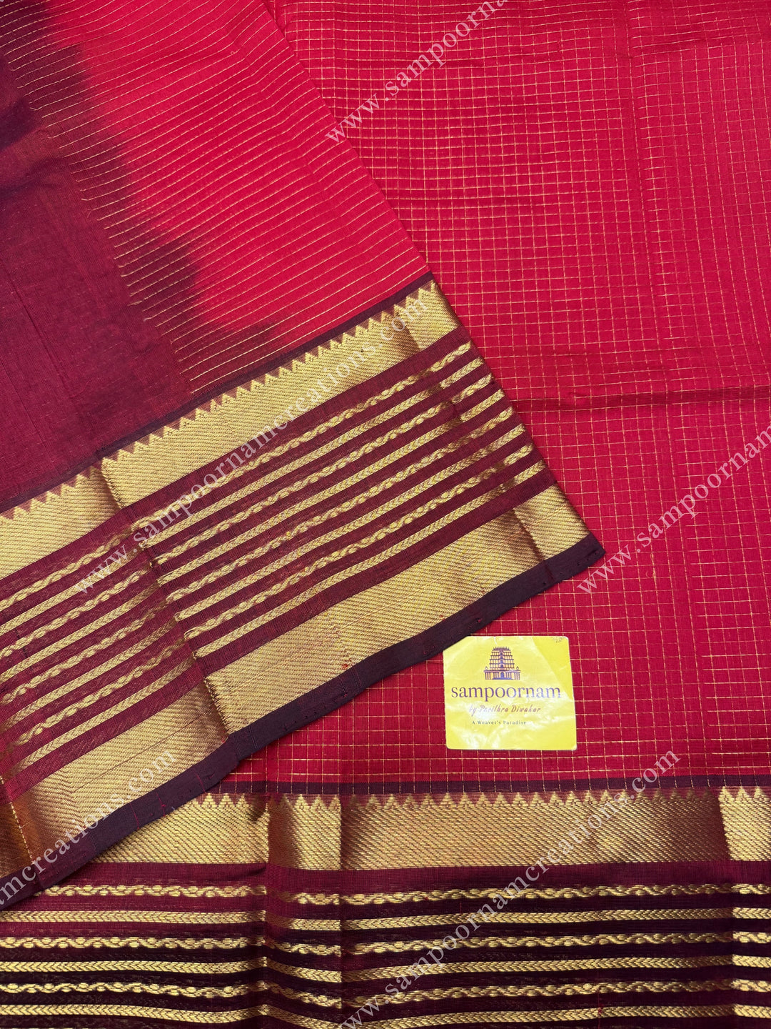 Red with Arakku , Zari checks in the body and One side long veldhari borders , rich Pallu Silk Cotton Saree