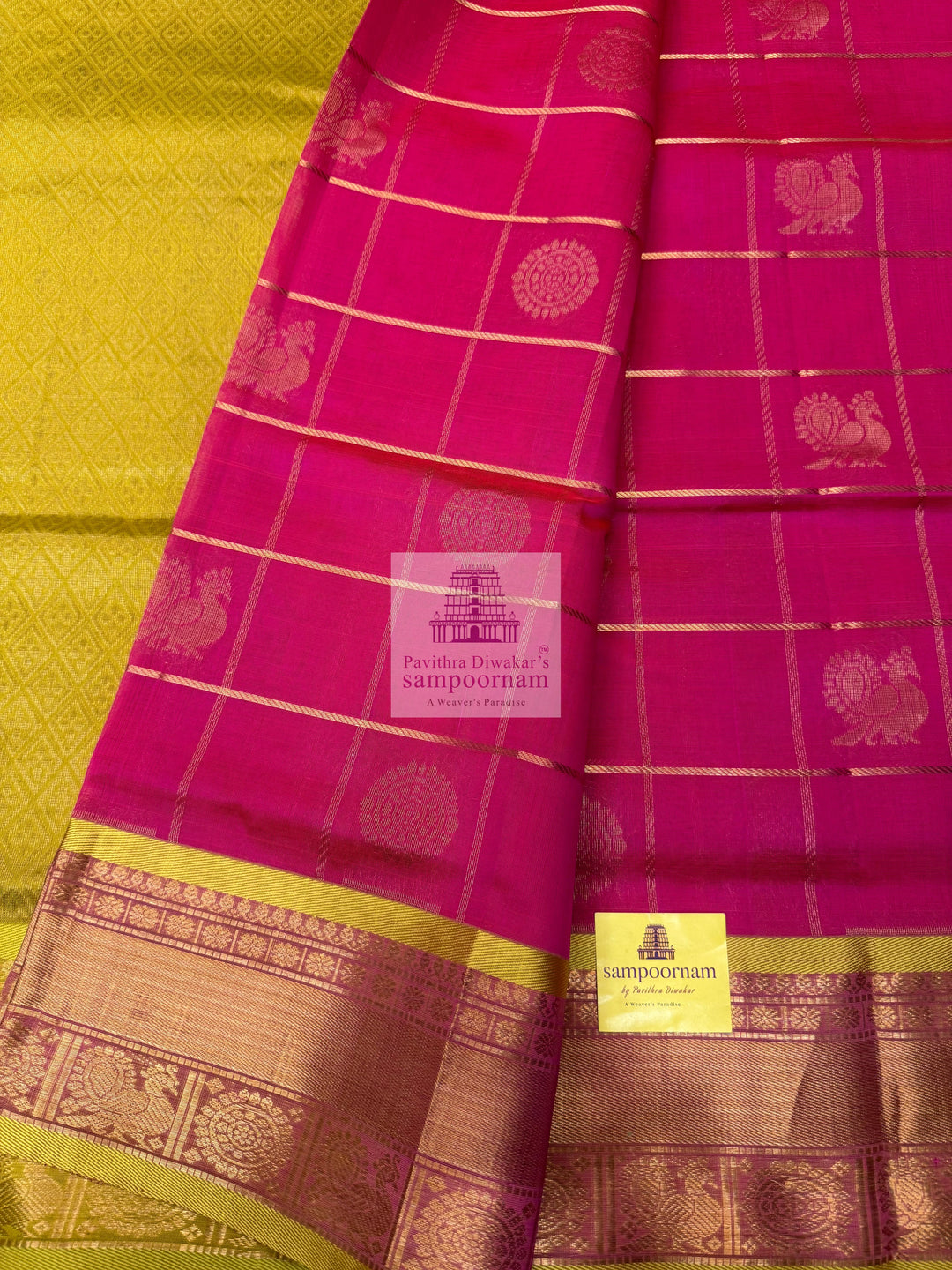 Rani pink with Lemon Yellow, , rich Zari checks in the body , Mayil and Chakram rich Zari butta in the body , traditional borders and rich Pallu Silk Cotton Saree