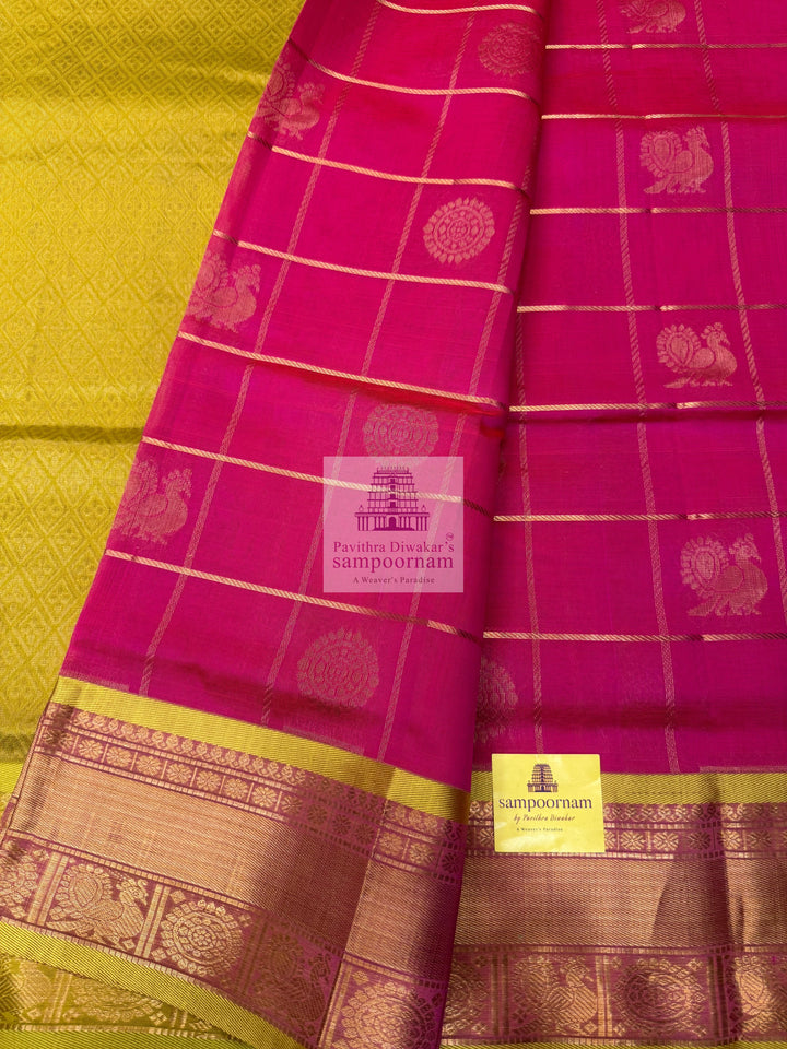 Rani pink with Lemon Yellow, , rich Zari checks in the body , Mayil and Chakram rich Zari butta in the body , traditional borders and rich Pallu Silk Cotton Saree