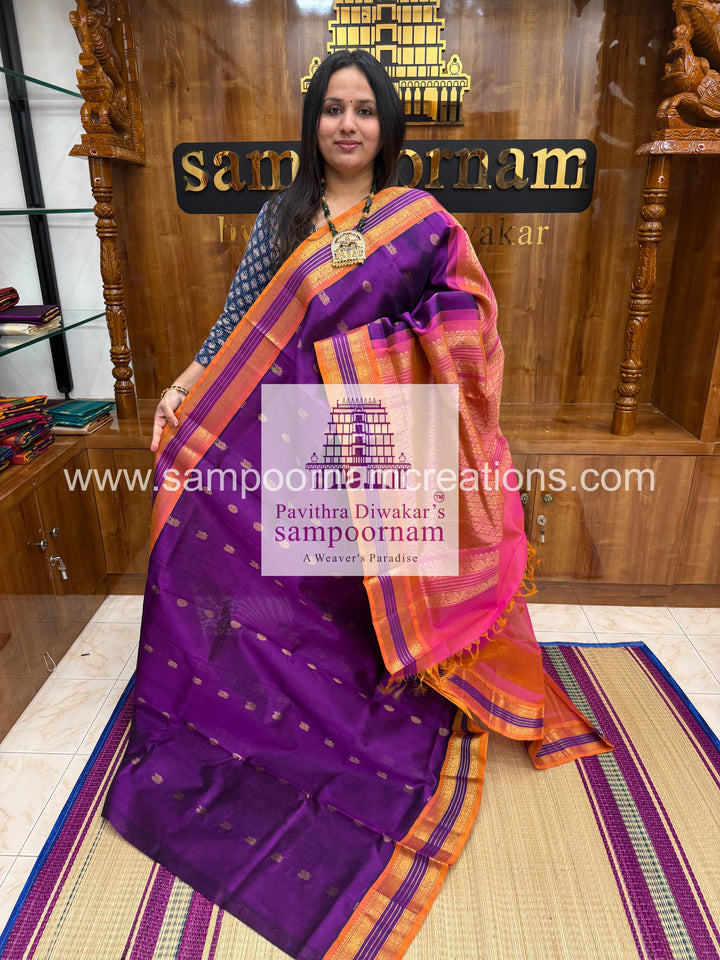 Purple with Peachish Pink , rich Zari butta in the body and Kanchi traditional borders and rich Pallu Korvai Silk Cotton Saree