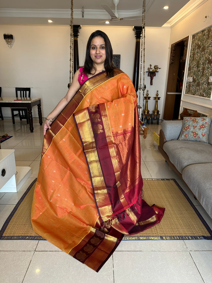 Orange with Araku Podi Kattam with Silver Butta in The Body and Satin Peacock Motif Border and Rich Pallu Korvai Silk Cotton Saree