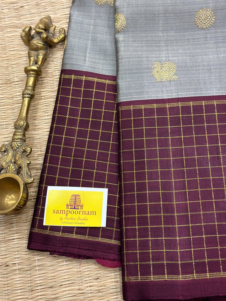 A Traditional Classic Grey with Araku Border Zari Checks Kanjivaram Silk Saree-Annam and Chakram Zari Motif in the body.Pure Zari/ Pure Silk