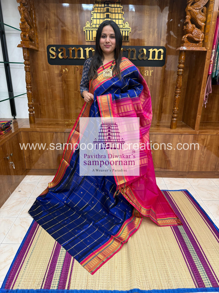 Blue with Pink , Zari checks in the body , rich Zari butta , traditional borders and rich Pallu Korvai Silk Cotton Saree