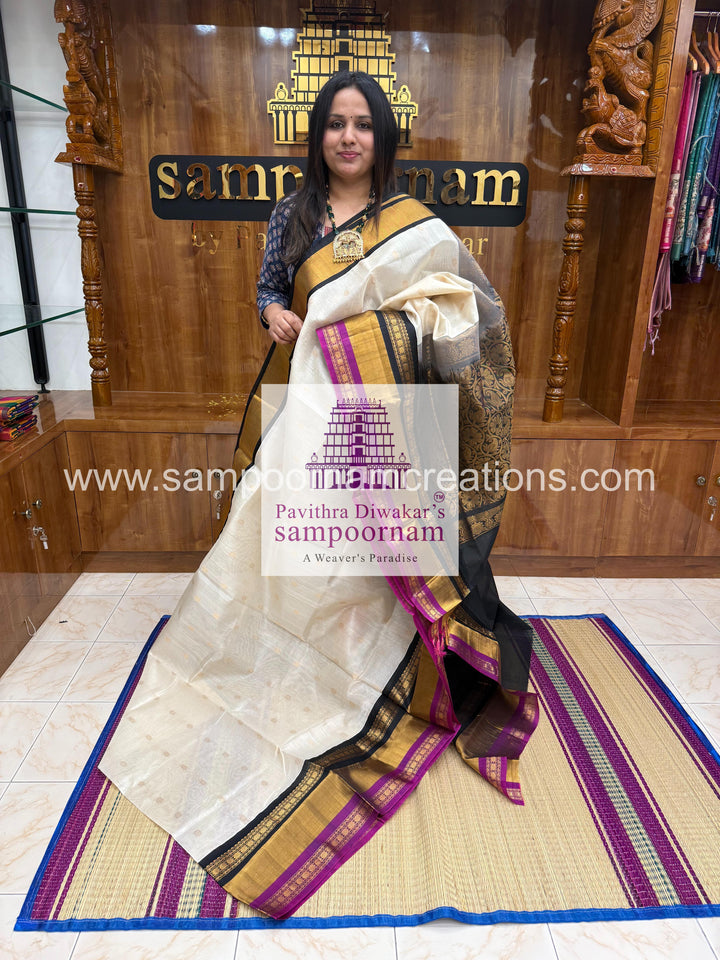 White with Black , triple one side big border , rich butta in the body and grand Pallu Korvai Silk Cotton Saree