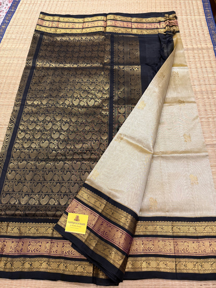 Gold with Black colour Rich Zari Butta in the body , Kanchi border and rich pallu Korvai Silk Cotton Saree