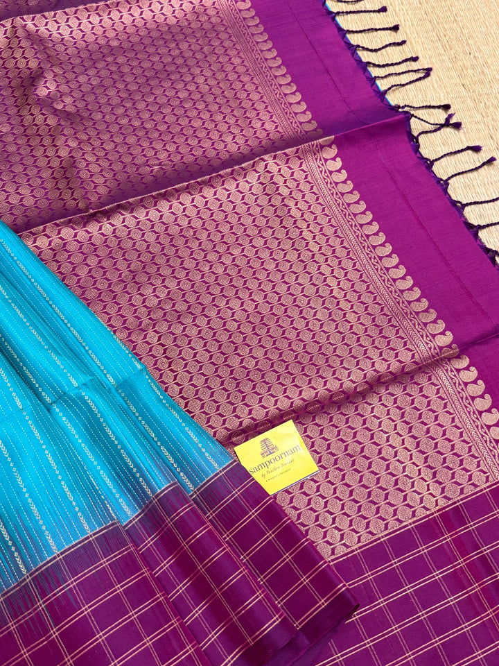 Rama Blue With Purple  colour , rich zari vertical line all over the body , traditional checks border and grand Pallu Pure Soft Silk Saree
