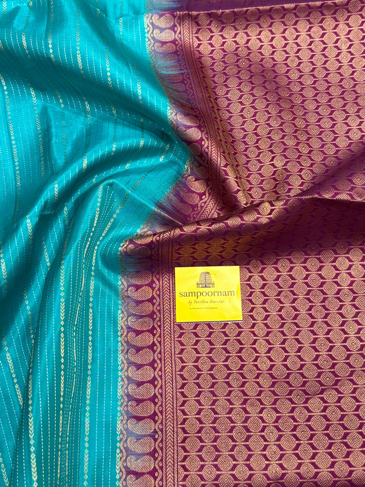 Rama Blue With Purple  colour , rich zari vertical line all over the body , traditional checks border and grand Pallu Pure Soft Silk Saree
