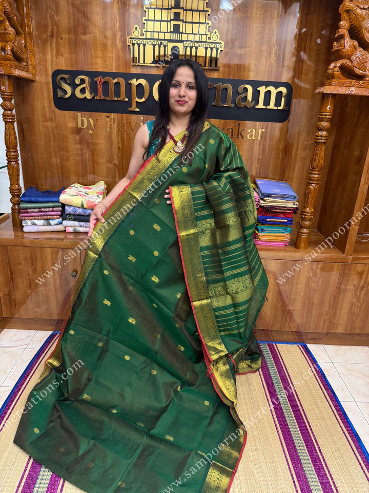 Green with Red Selvedge  , Zari butta in the body with  Vairaoosi Zari lines , traditional borders  and rich Pallu Silk Cotton Saree