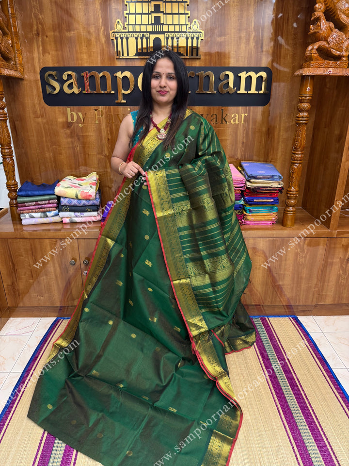 Green with Red Selvedge  , Zari butta in the body with  Vairaoosi Zari lines , traditional borders  and rich Pallu Silk Cotton Saree