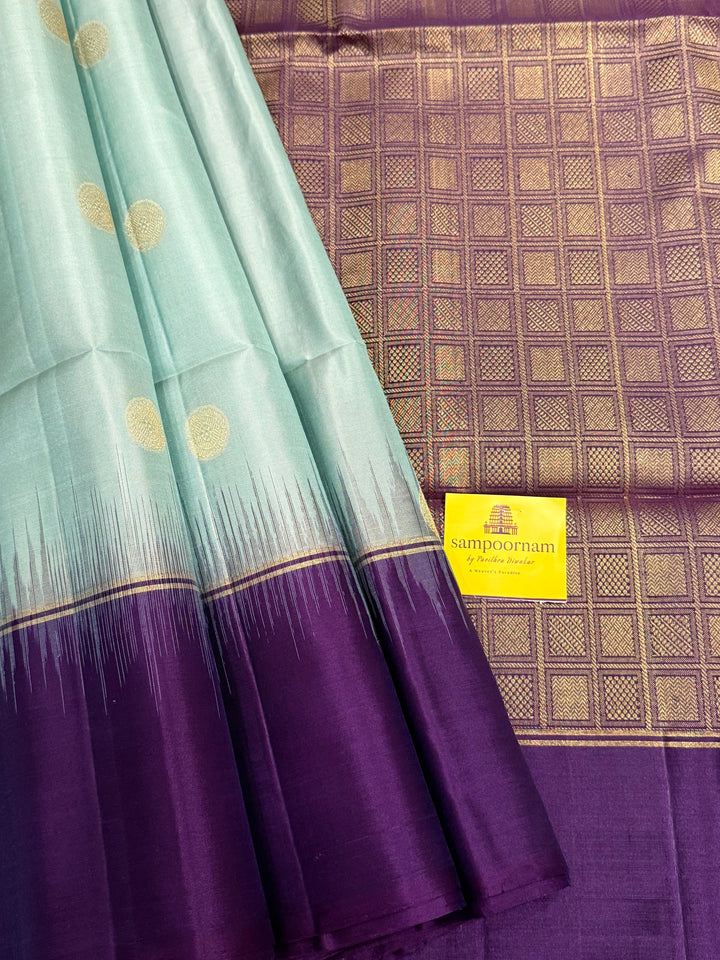 Ice Blue with Indigo, rich Rudraksha zari butta in the body and an elaborate rich Pallu Pure Soft Silk Saree