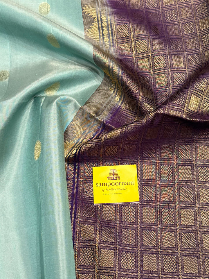 Ice Blue with Indigo, rich Rudraksha zari butta in the body and an elaborate rich Pallu Pure Soft Silk Saree