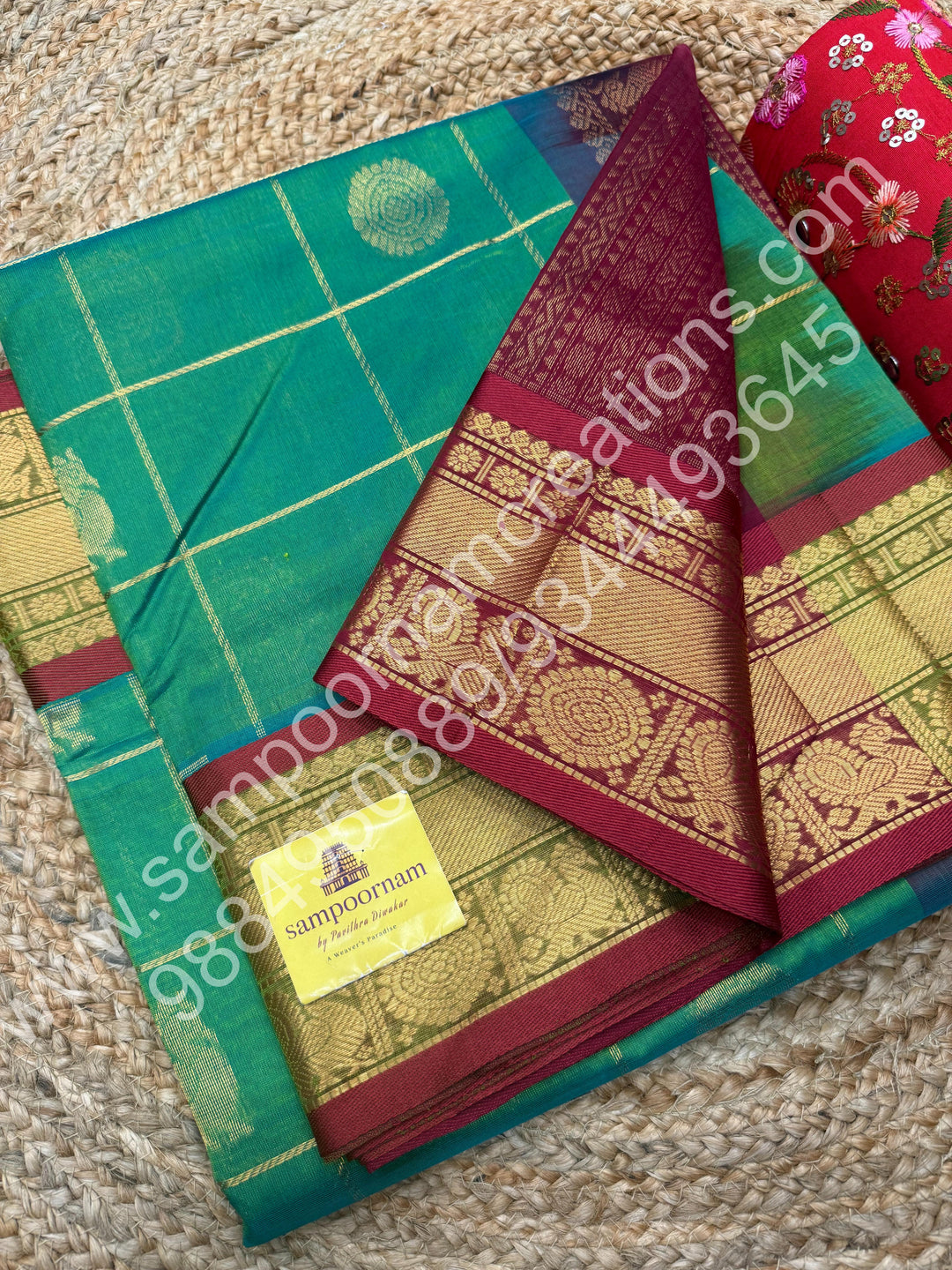 Double Shaded Rexona Green with Maroon  , Rich Mayil and Chakram butta in the body with Zari Checks , Traditional borders and Rich Pallu Pure Silk Cotton Saree