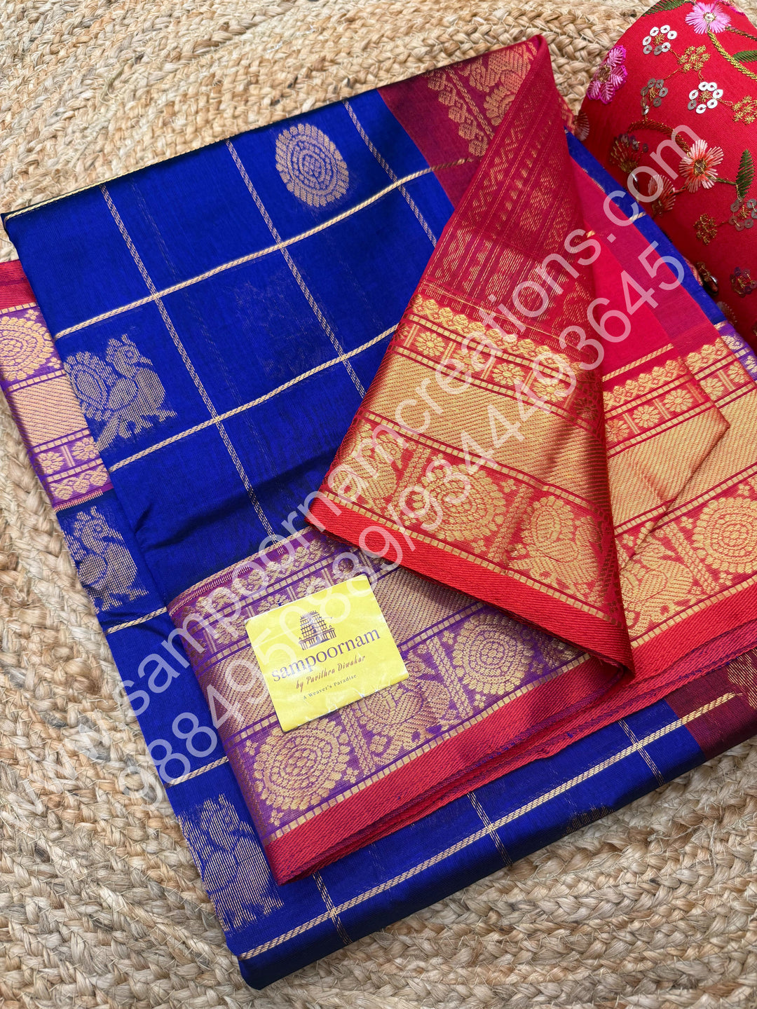 Indigo Blue with Red  , Rich Mayil and Chakram butta in the body with Zari Checks , Traditional borders and Rich Pallu Pure Silk Cotton Saree