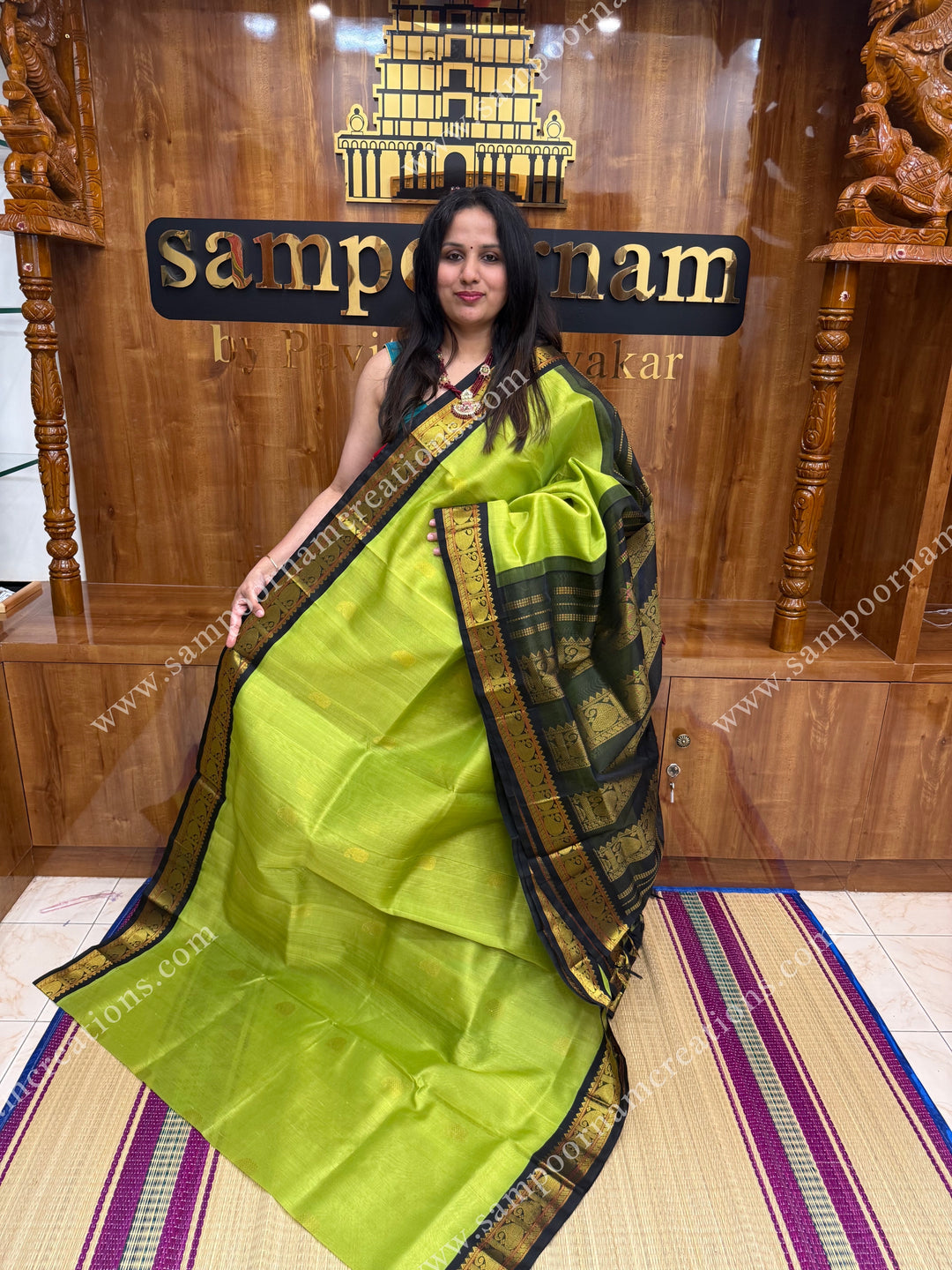 Parrot Green with Black , Rich Zari butta in the body and traditional borders ,  grand Pallu Korvai Silk Cotton Saree