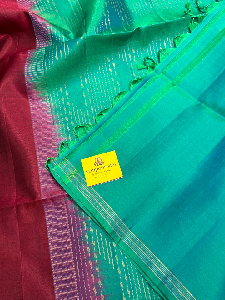 Deep Maroon With Turquoise Blue , rich annam butta in the lower border and small zari buttas in the body, rich Pallu Pure Soft Silk Saree